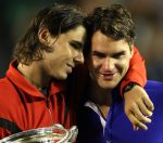 Rafael Nadal (L) of Spain embraces Roger Federer of Switzerland durin